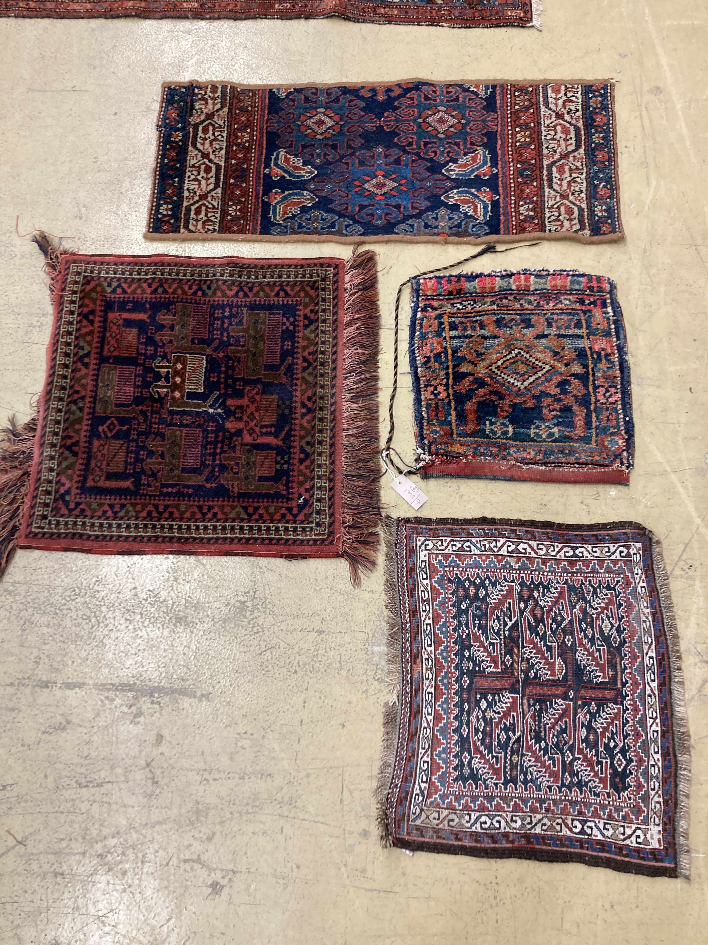 A Caucasian saddle bag and three mats, largest 100 x 40cm
